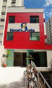 a hotel building with benches in front of it at Hotel Stela in Sao Paulo