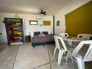 a bedroom with a bed and a table and chairs at XpuHa Bonanza in Xpu Ha +29 photos