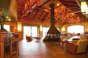 a large living room with a fireplace in a building at Loberias Del Sur in Puerto Chacabuco