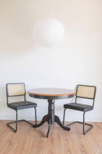 two chairs around a round table and a table and chairs at Modern East Side 1BR Apt with Balcony, Pool, and Gym in Milwaukee