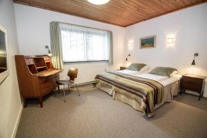 Ένα ή περισσότερα κρεβάτια σε δωμάτιο στο Dalby Hotel