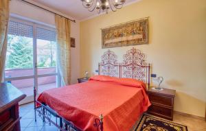 a bedroom with a red bed and a window at 2 Bedroom Beautiful Apartment In Stresa in Stresa