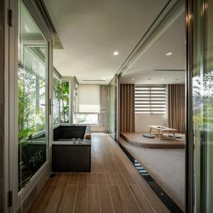 a hallway of a house with a bench and a table at Crownshine Resort in Jiaoxi