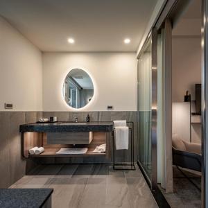 a bathroom with a sink and a mirror at Crownshine Resort in Jiaoxi