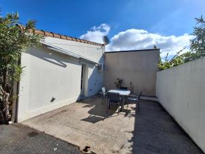 a small patio with a table and a fence at Appartement cosy avec mezzanine, proche plage et commerces - Châtelaillon-Plage - FR-1-706-29 in Châtelaillon-Plage +3 photos