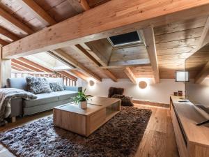 a living room with a couch and a table at Appartement Souplex Chaleureux aux Gets - 4 pers, 2 Ch. en Suite, proche du Centre et des Pistes - FR-1-598-170 in Les Gets