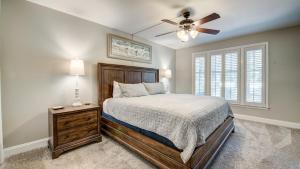 a bedroom with a bed and a ceiling fan at 142-2 A Peace of Pawleys condo by Peace Vacations in Pawleys Island