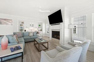 a living room with a couch and a fireplace at Seaside Serenity home by Peace Vacations in Pawleys Island +37 photos