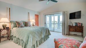 a bedroom with a bed and a sliding glass door at PP Villa #6 villa by Peace Vacations in Georgetown