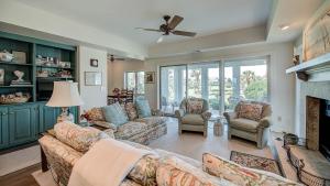 a living room with two couches and a fireplace at PP Villa #6 villa by Peace Vacations in Georgetown +27 photos