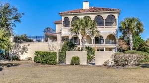 a large house with palm trees in front of it at Mull Cottage home by Peace Vacations in Georgetown
