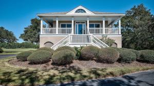 a large house with a porch and bushes at Good Trouble villa by Peace Vacations in Georgetown