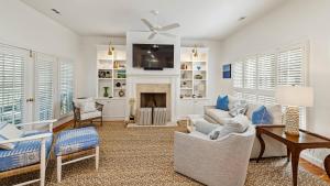 a living room with a couch and a fireplace at Salty Sister Villa by Peace Vacations in Georgetown