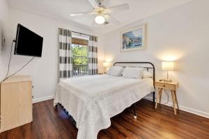 a bedroom with a bed and a flat screen tv at 52F True Blue Golf Getaway condo by Peace Vacations in Pawleys Island