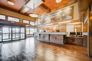a large lobby with a counter in a building at Holiday Inn West Yellowstone by IHG in West Yellowstone