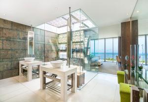 a bathroom with two sinks and a glass wall at W Bali - Seminyak in Seminyak