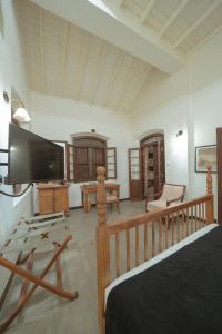 a bedroom with a bed and a tv in a room at Idda Private Pool Villa with Staff - 80m to Beach in Ahangama