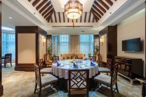 a large dining room with a table and chairs at Xinhua Media Hotel in Nanjing