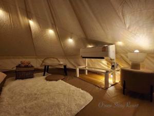 a room with a tent with a piano and a rug at โอโซนสตอรี่ in Ban Fai Mon