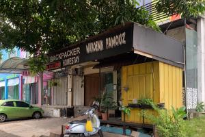 a scooter parked in front of a building at Backpacker Homestay Jatisampurna Redpartner in Bekasi