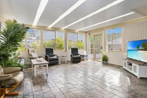 a large living room with a flat screen tv at Seaside Sanctuary in Hawks Nest