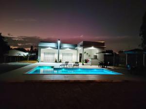 a house with a swimming pool at night at Chacara LP Boituva in Boituva