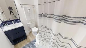 a bathroom with a sink and a shower curtain at Das Hartmann Haus - WiFi - Washer - Dryer - Grill - Fireplace in Red River
