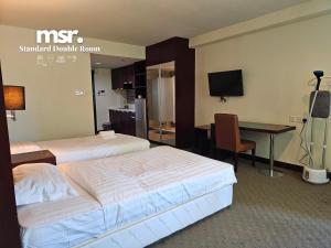 A bed or beds in a room at Kota Kinabalu City Ensuite at SCSP Ming Garden
