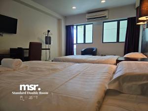 A bed or beds in a room at Kota Kinabalu City Ensuite at SCSP Ming Garden