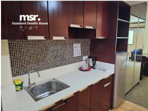 A kitchen or kitchenette at Kota Kinabalu City Ensuite at SCSP Ming Garden