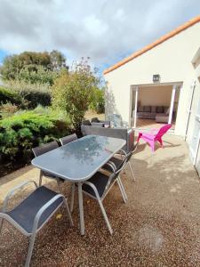 a patio with a table and chairs and a couch at Maison de vacances Angles in Angles