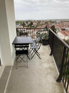 a balcony with a table and chairs and a view at Appartement T3 classé 3 étoiles in Bayonne