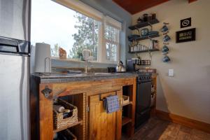 a kitchen with a counter with a sink and a stove at Meadow Cabin at Highland Meadows - Secluded Getaway in Hot Springs +12 photos