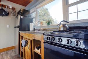 a kitchen with a stove and a sink at Meadow Cabin at Highland Meadows in Hot Springs