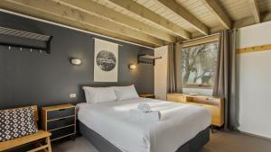a bedroom with a large bed and a window at Aaragon in Dinner Plain
