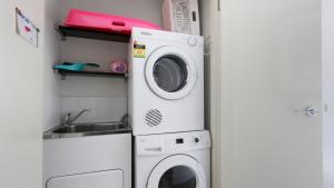 a kitchen with a washing machine and a sink at Apres in Dinner Plain