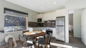 a kitchen and dining room with a table and chairs at Apres in Dinner Plain +2 photos