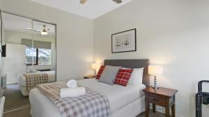 a bedroom with a bed and a table with lamps at Apres in Dinner Plain