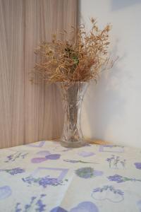 a vase with flowers in it sitting on a table at Apartmani Vidušin in Novalja