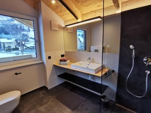 a bathroom with a sink and a shower at Chalet Schlossalm bis 9 Personen in Bad Hofgastein +12 photos