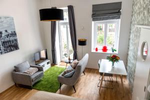 a living room with a table and chairs at Boutique Apartments Vienna in Vienna