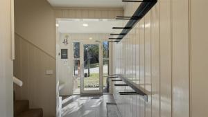 a hallway of a house with stairs and a window at Numbawan in Dinner Plain