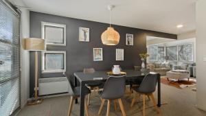a dining room with a black table and chairs at Numbawan in Dinner Plain