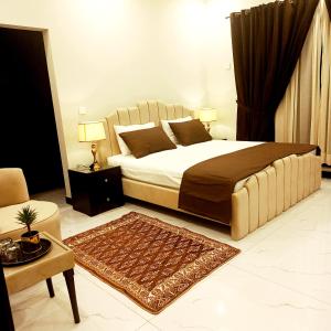 a bedroom with a large bed and a living room at Riwayat Guest House in Islamabad +25 photos