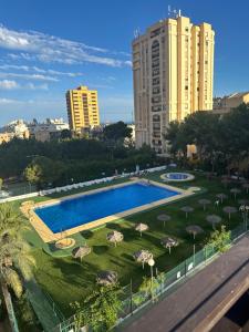 vistas a una piscina con sombrillas y edificios en 3 dormitorios aguadulce pool, en Aguadulce