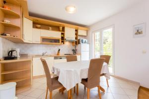a kitchen with a table and chairs in a kitchen at Apartment Mia - Spacious apartment on 85 m2 with beautiful sea view in Trogir