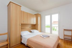 a bedroom with a bed and a large window at Apartment Mia - Spacious apartment on 85 m2 with beautiful sea view in Trogir