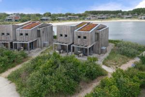 an aerial view of a row of wooden houses on the water at Studio Waterfront | 2 Pers. in Ouddorp