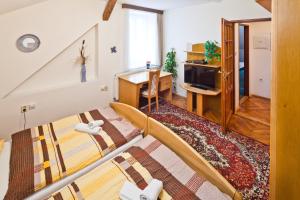 a living room with a staircase leading to a living room at Pension Fontána Svitavy in Svitavy