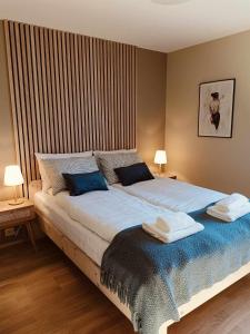 a bedroom with a large bed with two towels on it at Holiday home in Steinkjer in Steinkjer